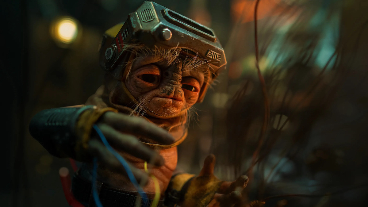 The alien character Babu Frik working among a tangle of electrical wires from a scene in Star Wars: The Rise of Skywalker