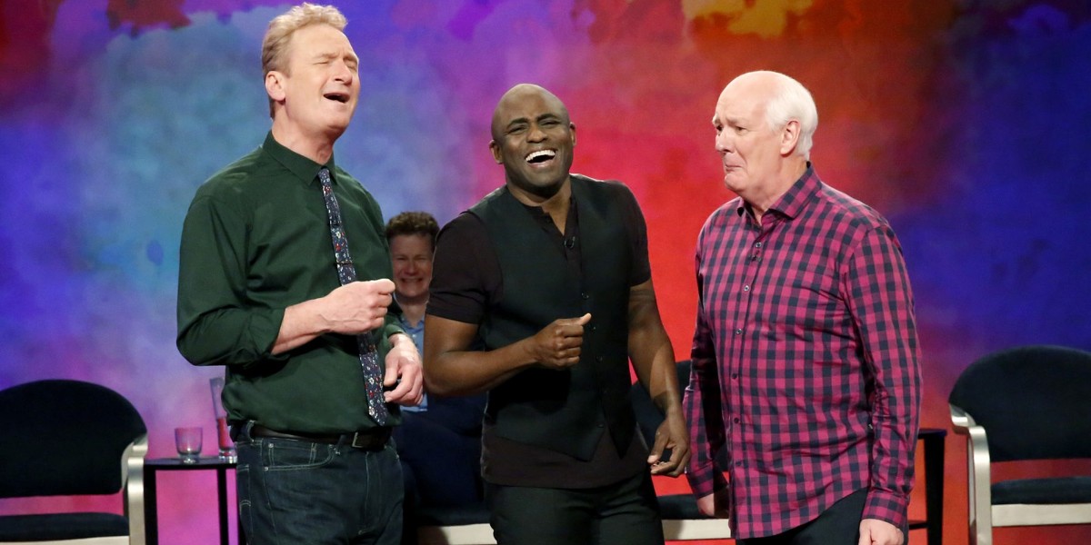 Colin Mochrie, Ryan Stiles, and Wayne Brady performing on Whose Line Is It Anyways?