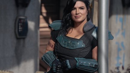 Gina Carano as Cara Dune in The Mandalorian, leaning against an architectural column, looking pensively into the distance