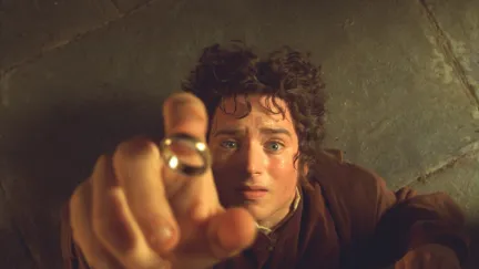 Frodo looks up at the One Ring as it's about to go on his finger