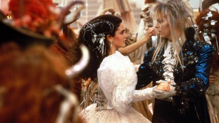 Jennifer Connelly as Sarah Williams dancing at a masquerade ball with David Bowie as the Goblin King Jareth in the film Labyrinth