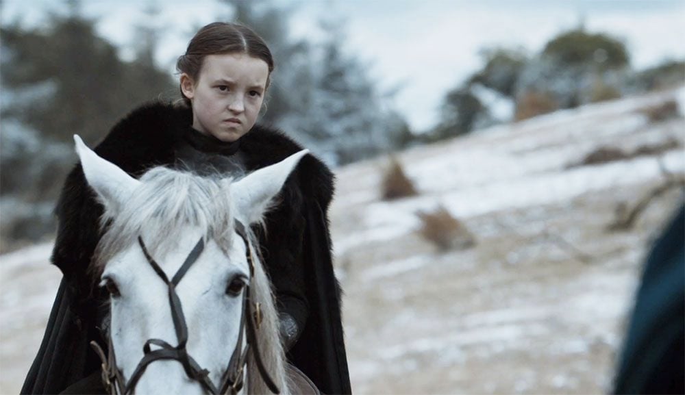 Lyanna Mormont, played by Bella Ramsay, looks in disgust at Ramsey Bolton during Game of Thrones' the Battle of the Bastards