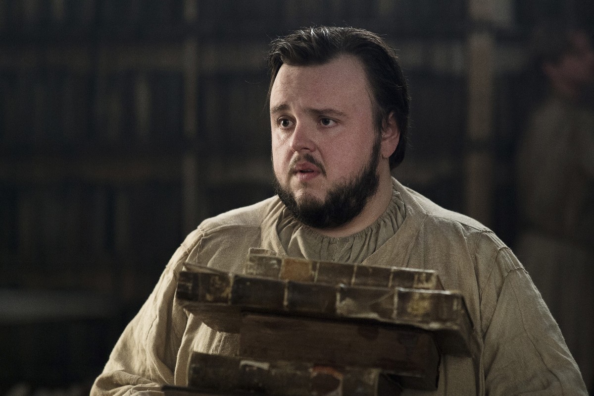 Samwell Tarly holds a stack of books in 'Game of Thrones'