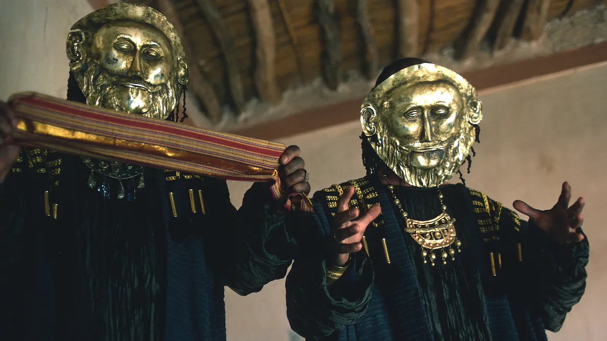 Two robed figures wearing sculpted metal masks from the film Time Bandits