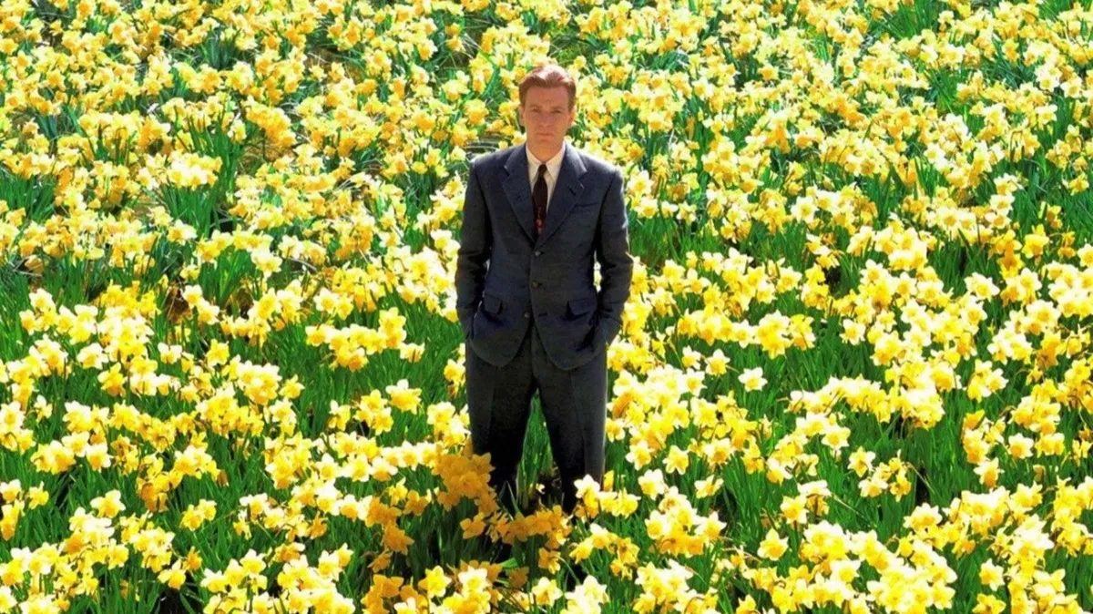 A man stands in a field of yellow flowers in "Big Fish"