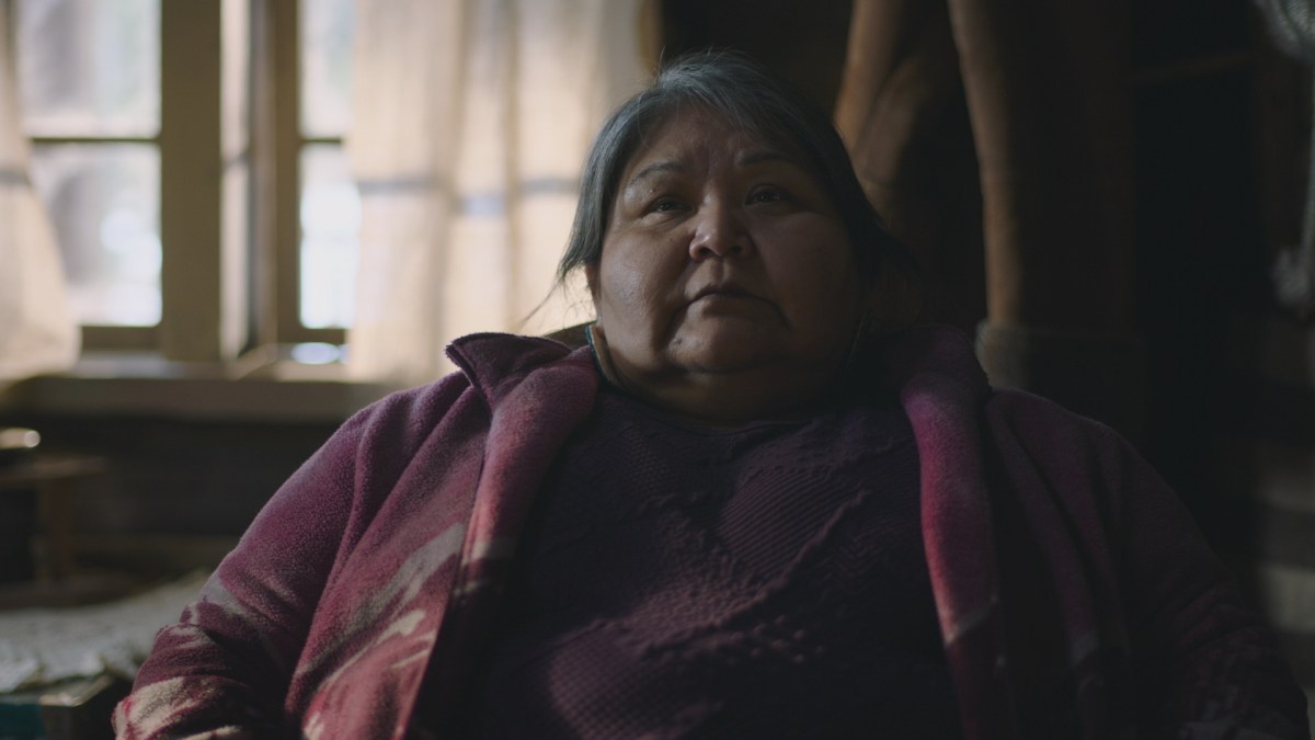 Elaine Miles sits in a chair, wearing a purple sweater, in The Last of Us episode 6.