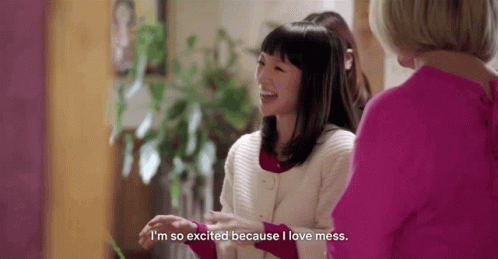 Marie Kondo smiles and gestures. Subtitles read, "I'm so excited because I love mess."
