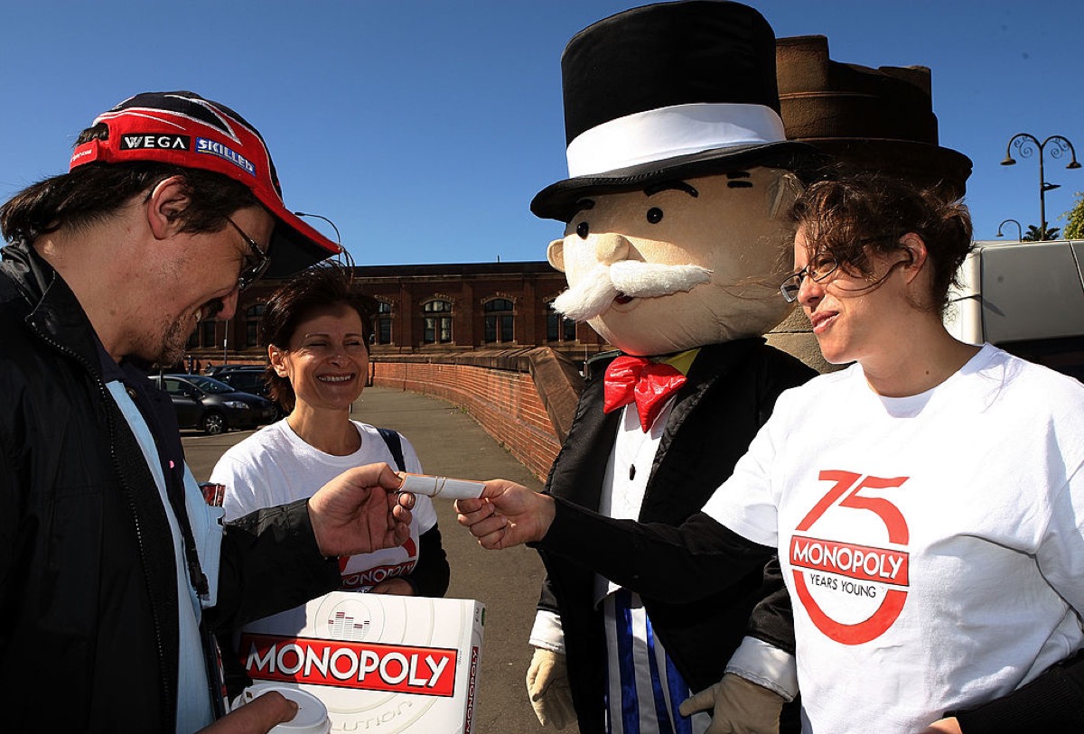 Monopoly promotions staff hand out Monopoly notes to Sydneysiders on Oxford Street during Monopoly's 75th anniversary celebration on August 25, 2010 in Sydney, Australia.