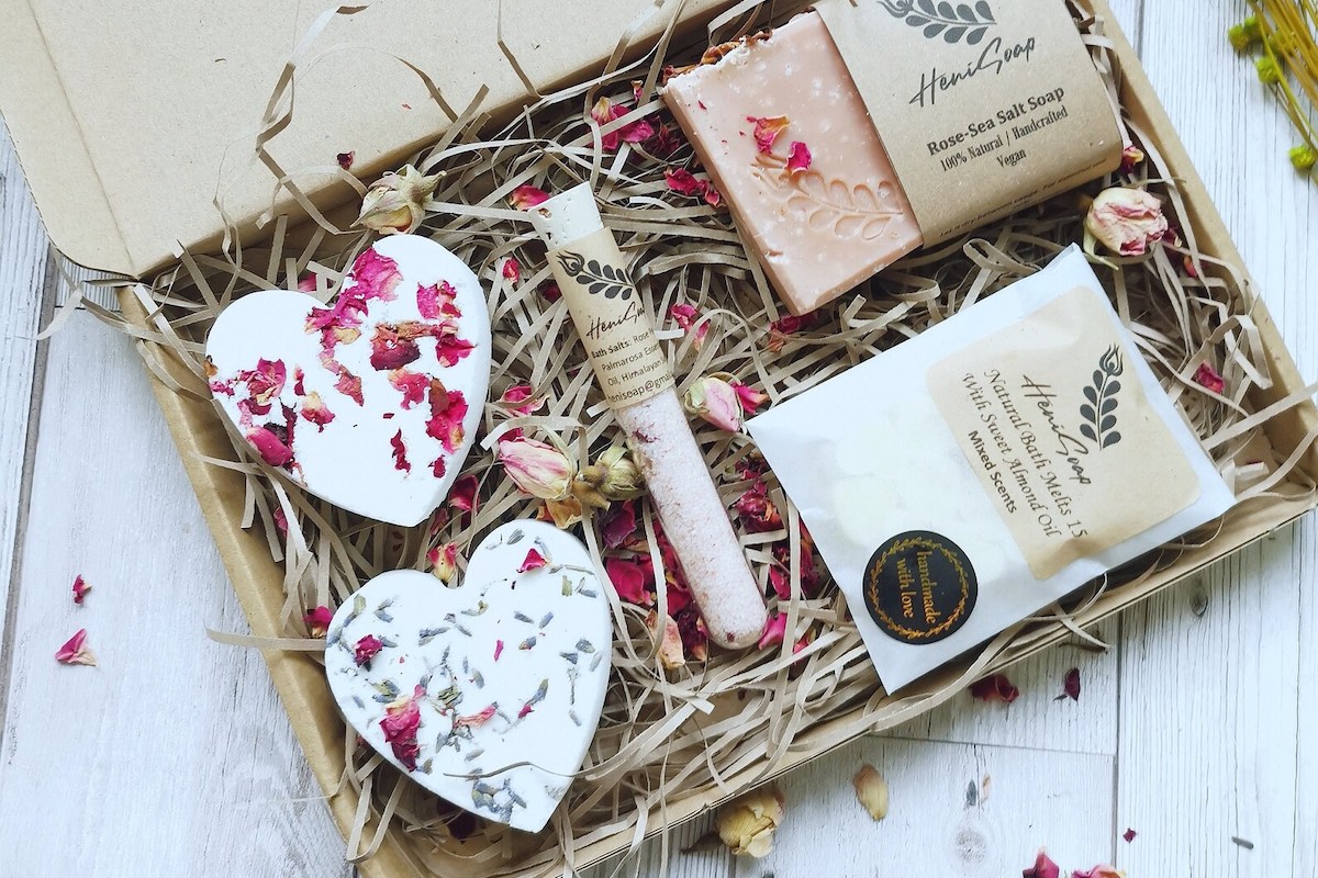A hamper with heart shaped items and a vial of bath salts