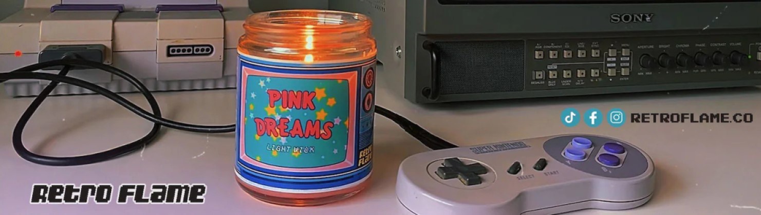Pink Dreams candle from RetroFlameCo alongside an SNES system and classic TV