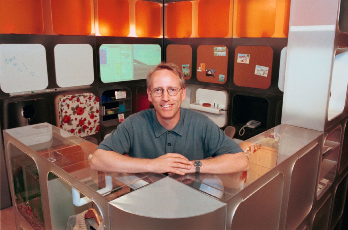 Scott Adams, famed creator of the comic strip DILBERT stands within "Dilbert's Ultimate Cubicle" which offers practical and humorous concepts for the future workplace office.