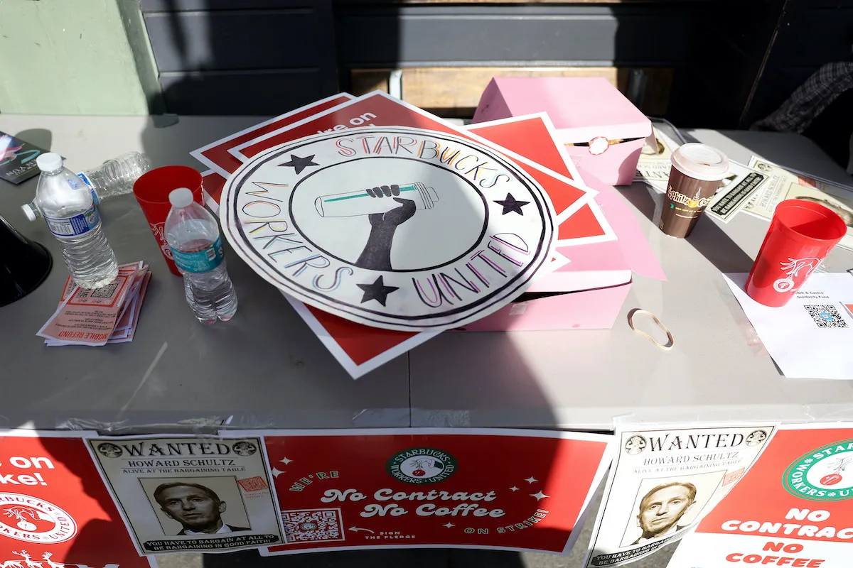 Pro-Starbucks union signs displayed on a table.