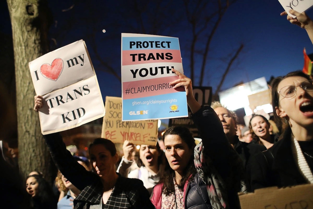 A group of protesters holding signs reading "protect trans youth" and "I Heart My Trans Kid" Spencer Platt/Getty Images