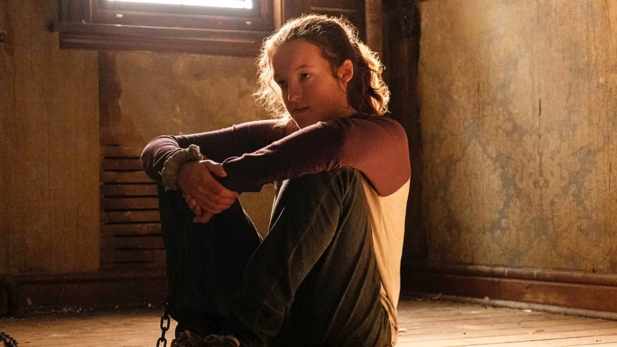 Bella Ramsey as Ellie sitting chained up in The Last of Us