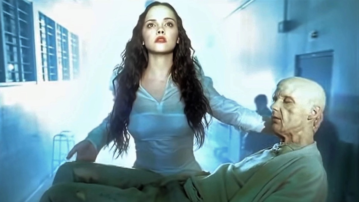 The Angel of Death (Christina Ricci) carries an elderly man (Moby) in her arms in the music video for "Natural Blues" 