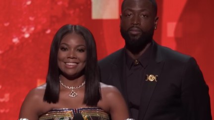 Gabrielle Union and Dwyane Wade stand on stage