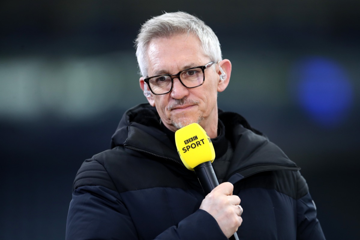 Gary Lineker looks disappointed while holding a BBC Sport microphone