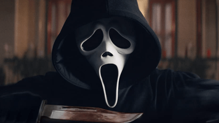 Ghostface in Scream, holding a bloody knife.