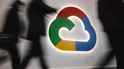 People walk in front of the Google Cloud's booth during the day 3 of the Mobile World Congress 2023