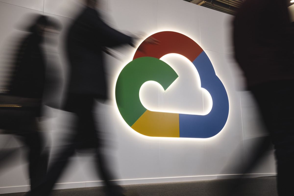 People walk in front of the Google Cloud's booth during the day 3 of the Mobile World Congress 2023
