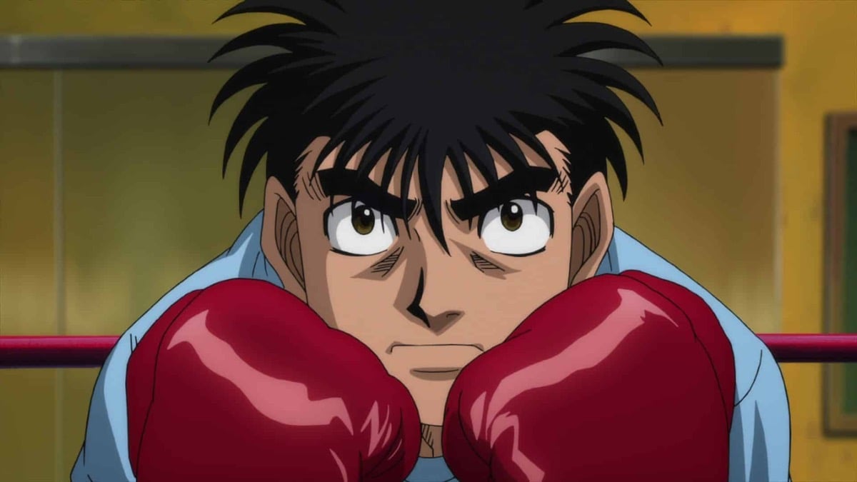 A young boy stands in a boxing ring with his dukes raised in "Hajime no Ippo: Rising" 