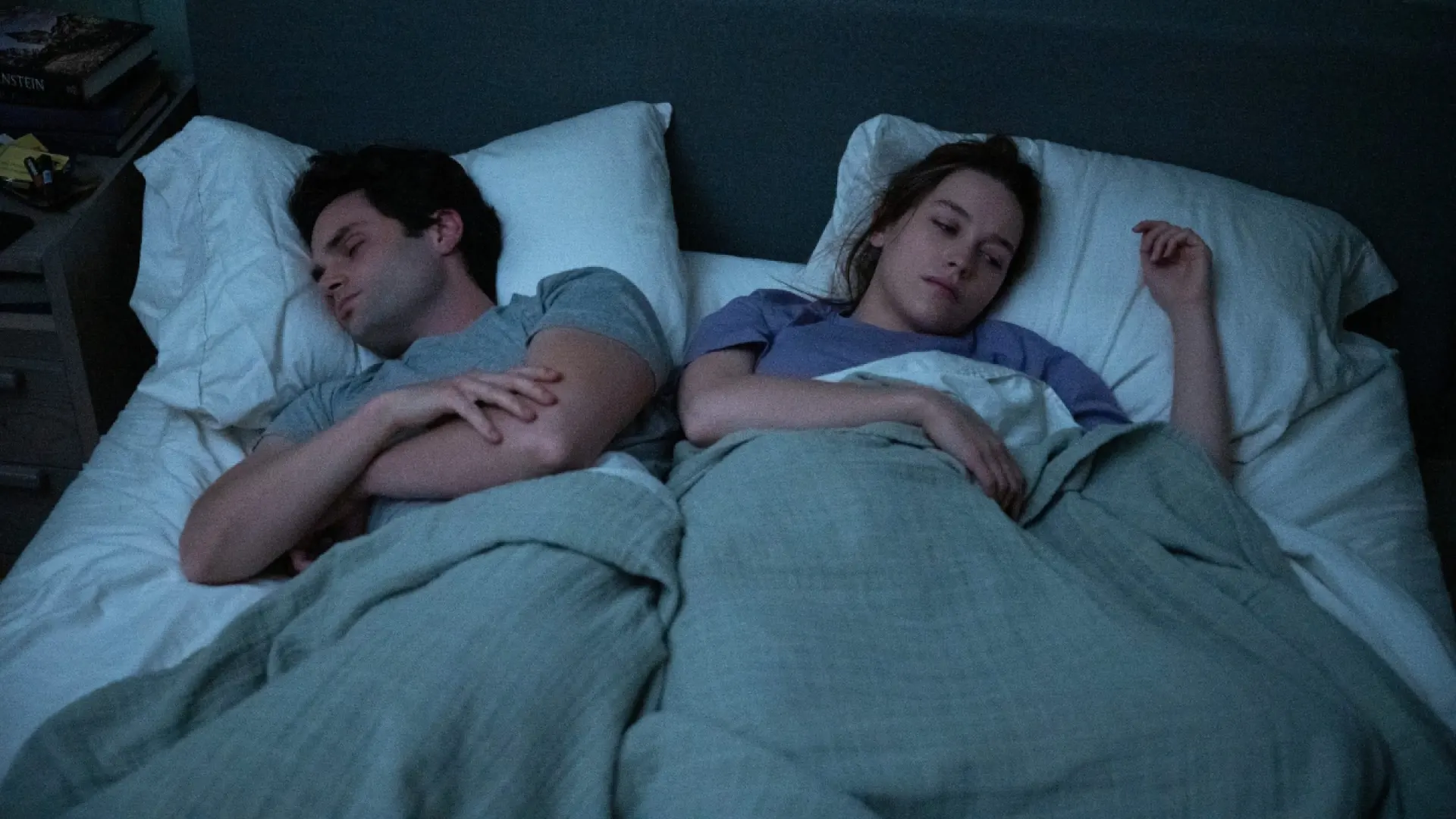 Joe and Love laying down in bed in You Season 3
