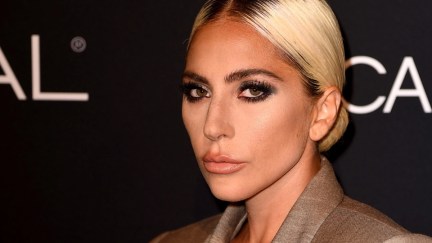 Lady Gaga, wearing a beige blouse, looks deadpan at the camera. (Kevin Winter/Getty Images)