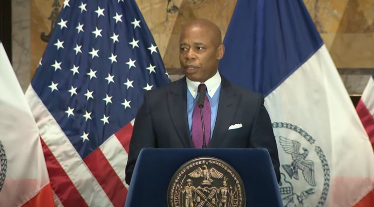 Mayor Eric Adams speaks from a podium.