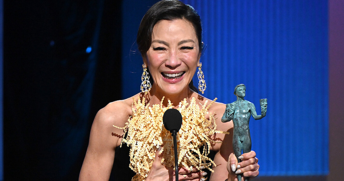 Michelle Yeoh onstage at the 2023 SAG Awards, holding her Actor statuette in her left hand