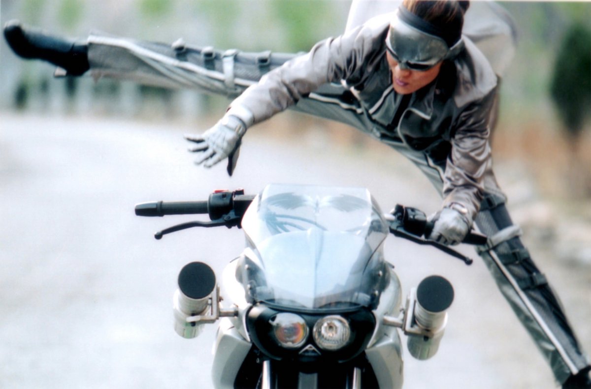 Michelle Yeoh leaping onto a motorbike in 'Silver Hawk'