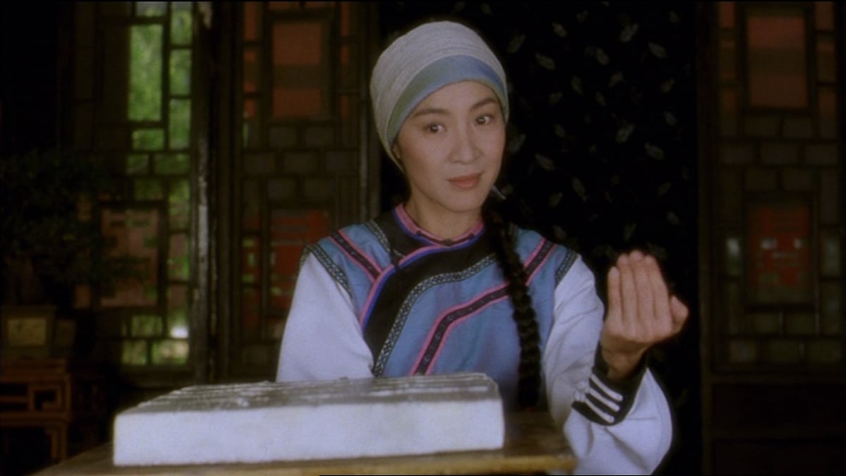 Michelle Yeoh as the character Yim Wing-Chunin the film Wing Chun, seated at a counter over a block of tofu