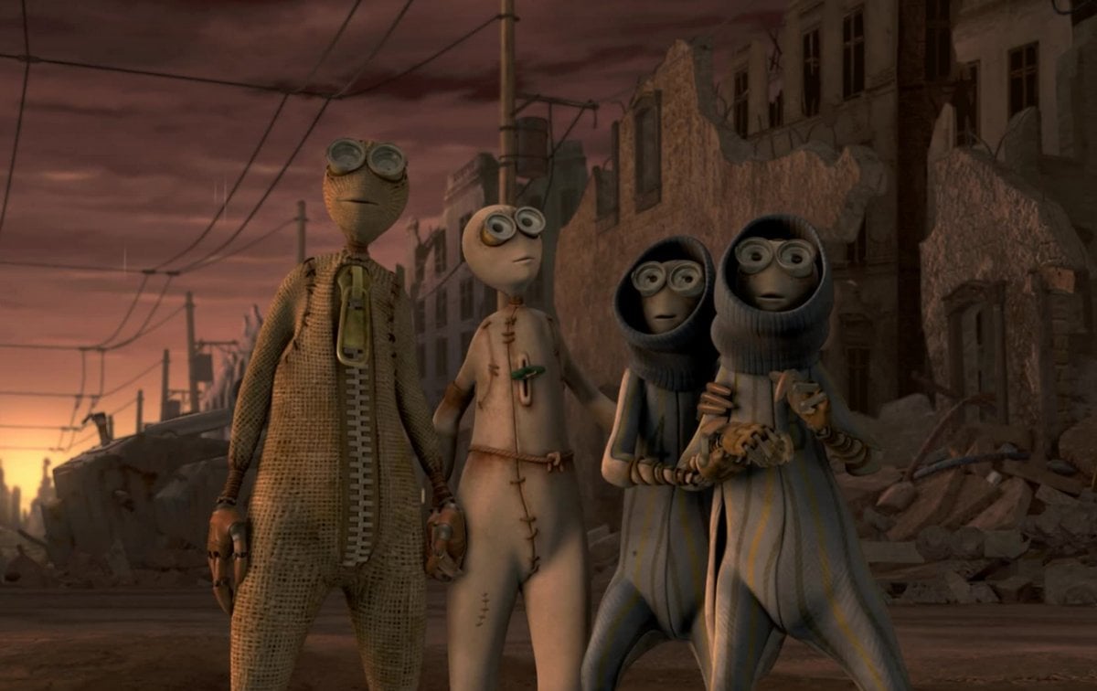 Four cute little doll people standing in an apocalyptic scene (Focus Features)