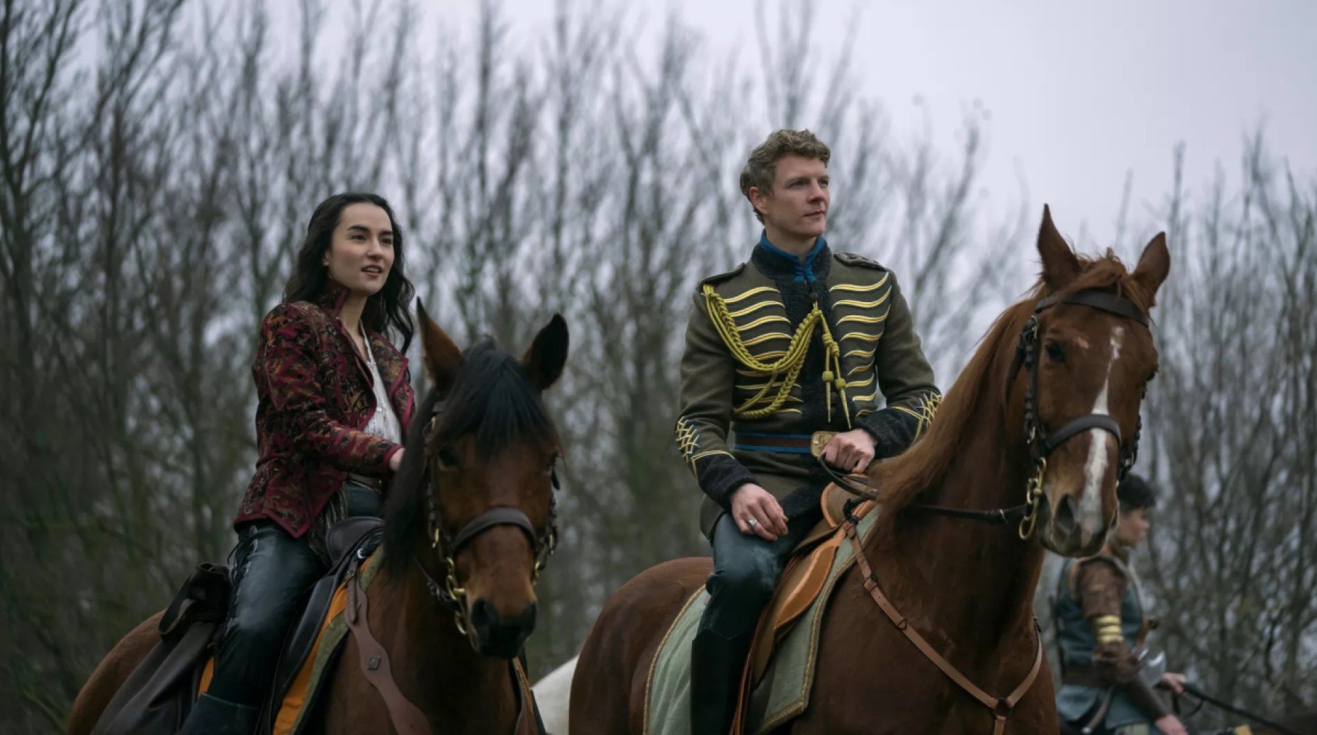 Alina (Jessie Mei Li) and Nikolai (Patrick Gibson) sit atop horses on 'Shadow and Bone' season 2