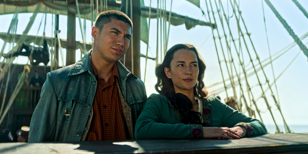 Archie Renaux as Mal Oryetsev and Jessie Mei Li as Alina Starkov on a ship in Shadow and Bone season 2