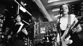 Sleater Kinney performing at Tower Records, as photographed by Corin Tucker's husband Lance Bangs.