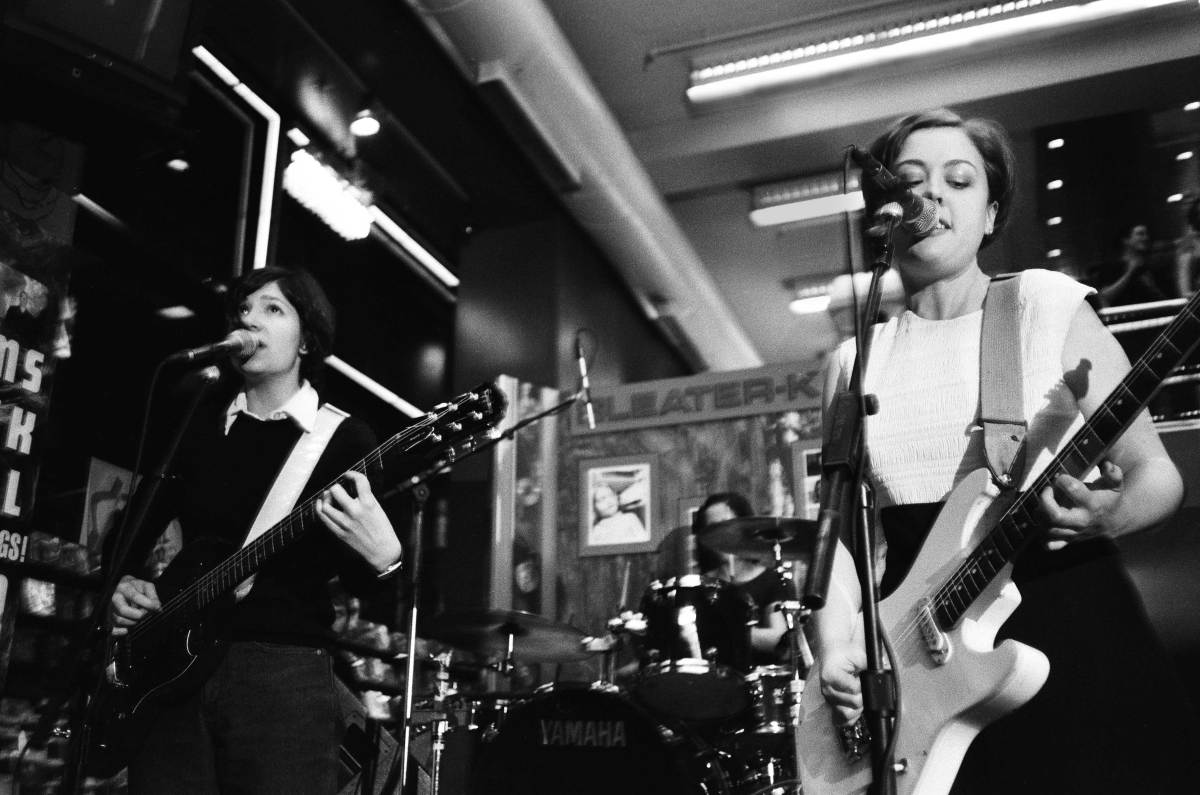 Sleater Kinney performing at Tower Records, as photographed by Corin Tucker's husband Lance Bangs. 