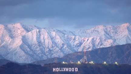 The Hollywood sign stands in front of snow-covered mountains after another winter storm hit Southern California on March 1.