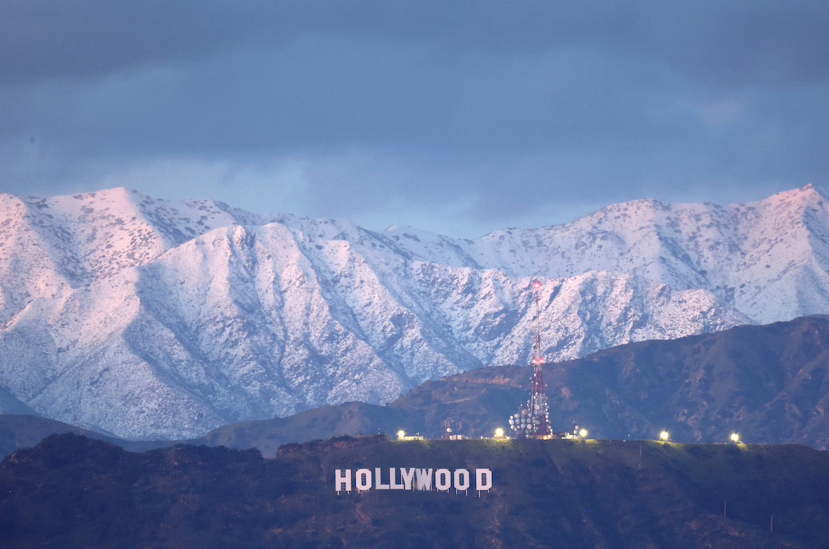 The Hollywood sign stands in front of snow-covered mountains after another winter storm hit Southern California on March 1.