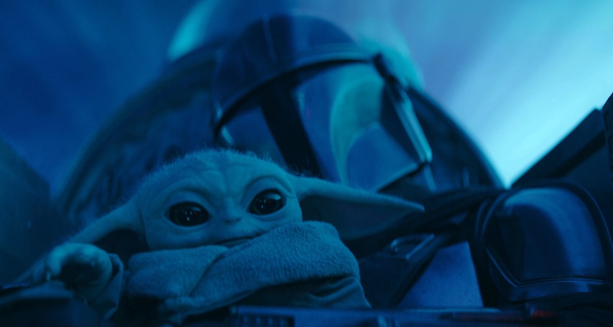 Din Djarin and Grogu cuddle up as they travel on their ship in the newest episode of season 3 of The Mandalorian