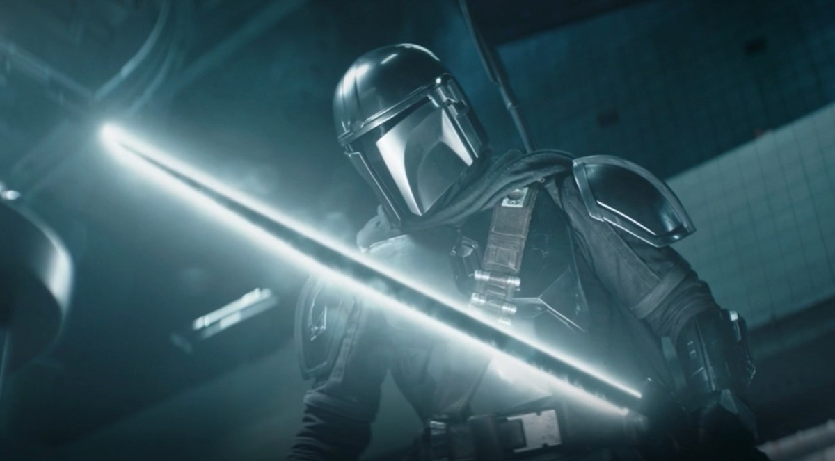 The Mandalorian wields his Darksaber as he chases quarries in The Book of Boba Fett