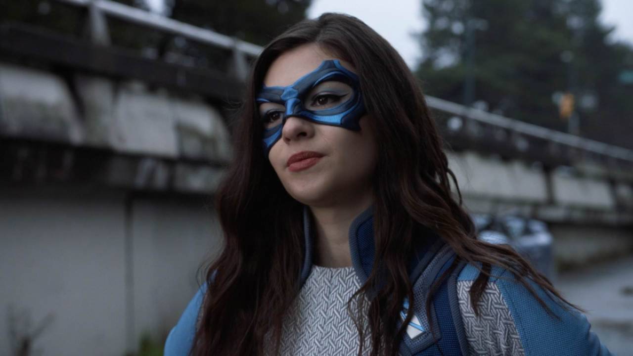 Nia Nal wears her superhero suit and mask
