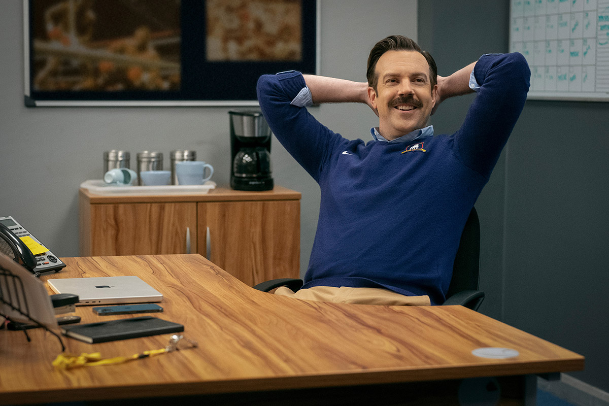 Ted Lasso (Jason Sudeikis) in a chair on Ted Lasso