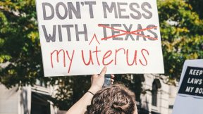 Woman at Texas abortion ban protest with a sign that reads 