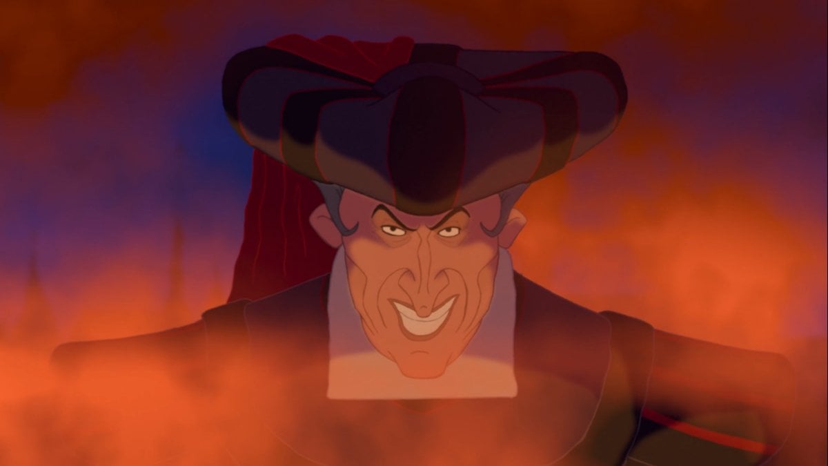 Judge Frollo smiling evilly through fire and smoke (Disney)