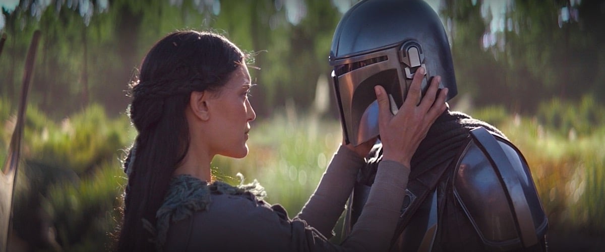The Mandalorian is about to have his helmet removed by a woman