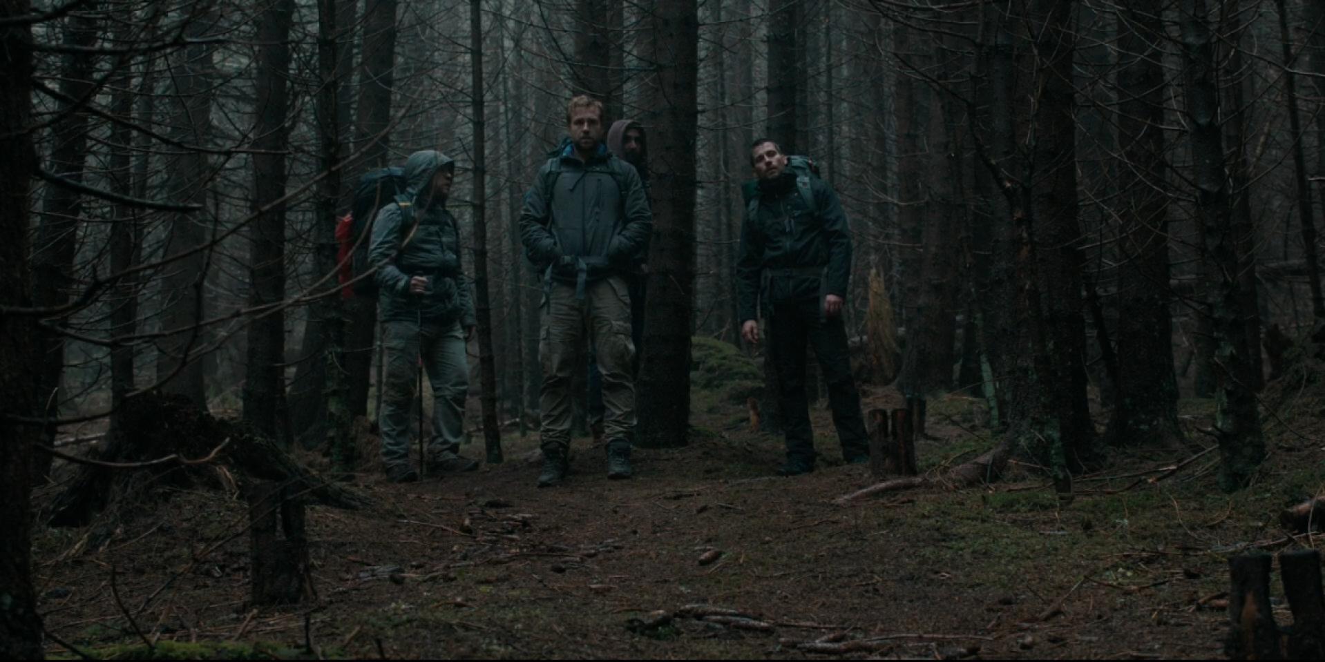 The friends standing in the woods in The Ritual