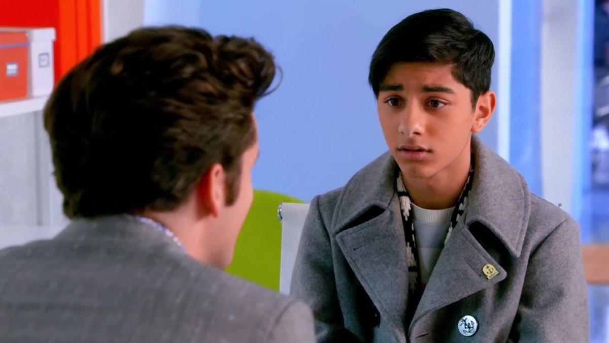 Justin Suarez wears a dark wool coat as he talks to someone