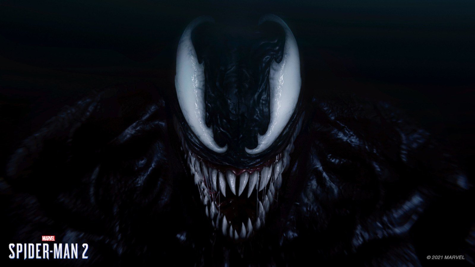 Venom grins creeply against a black background