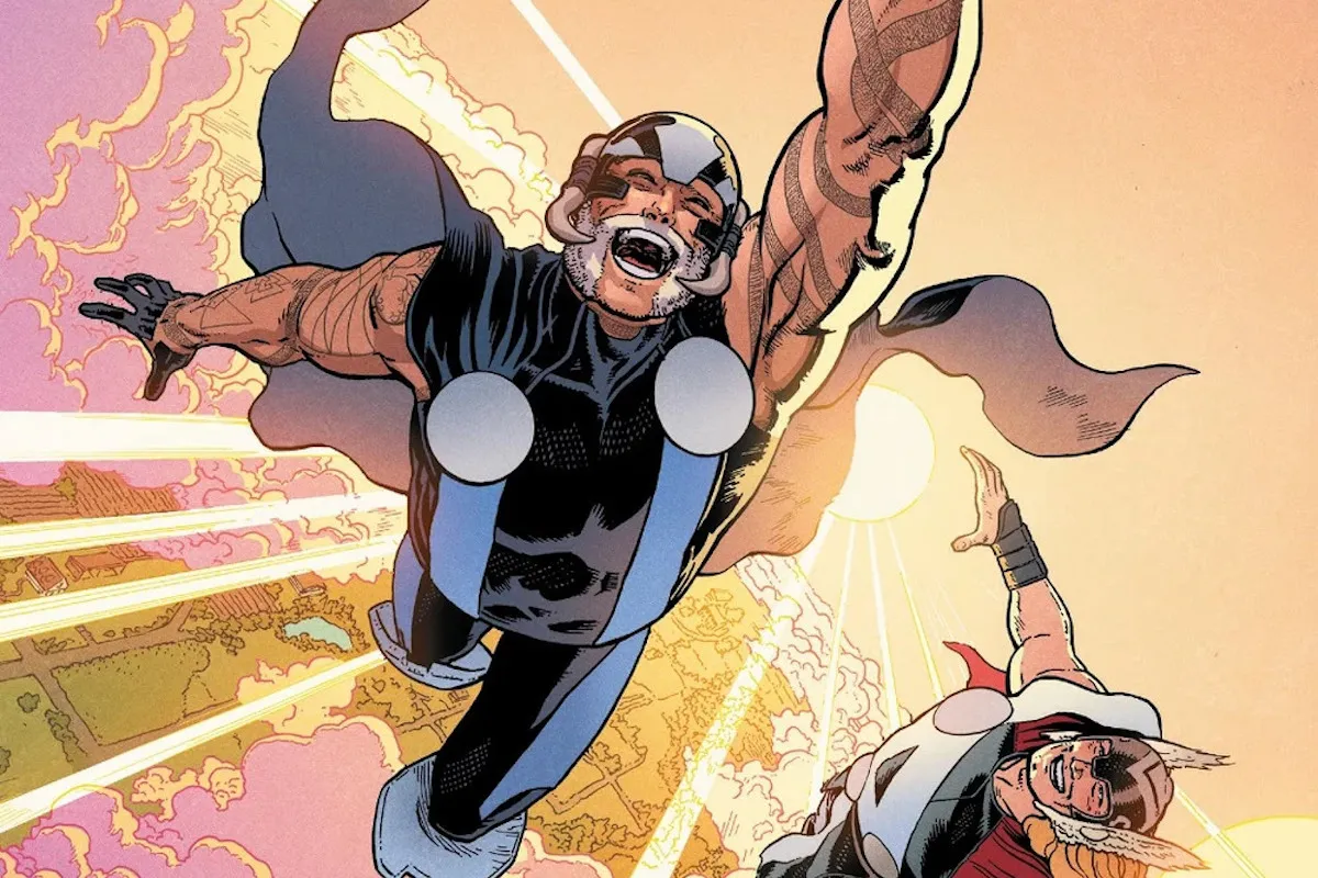 A grey haired man in black super suit and helmet flies using Thor's hammer, mouth open in a grin. Thor flies below him also grinning.