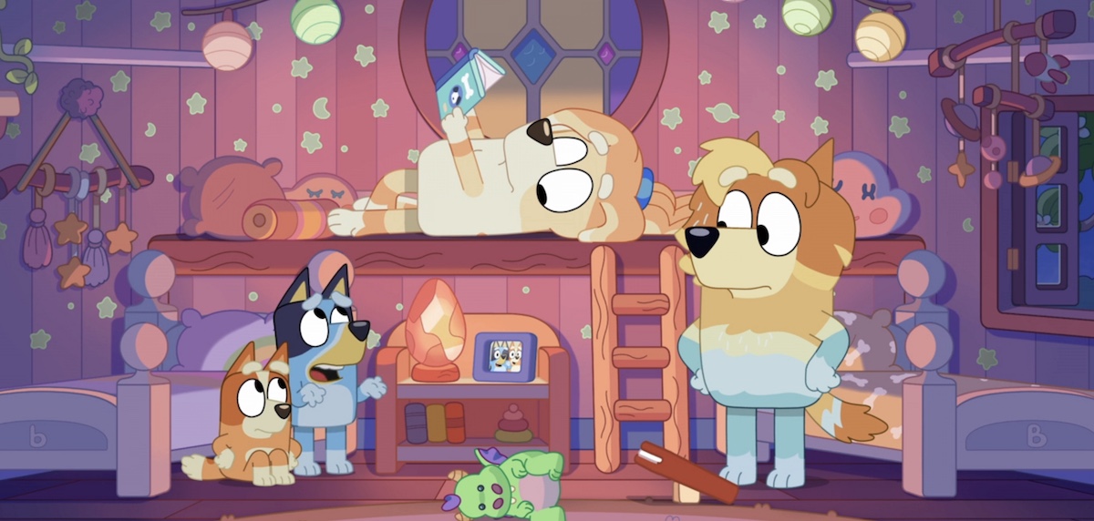 Bluey, Bandit, and two babysitters sit in their bedroom.